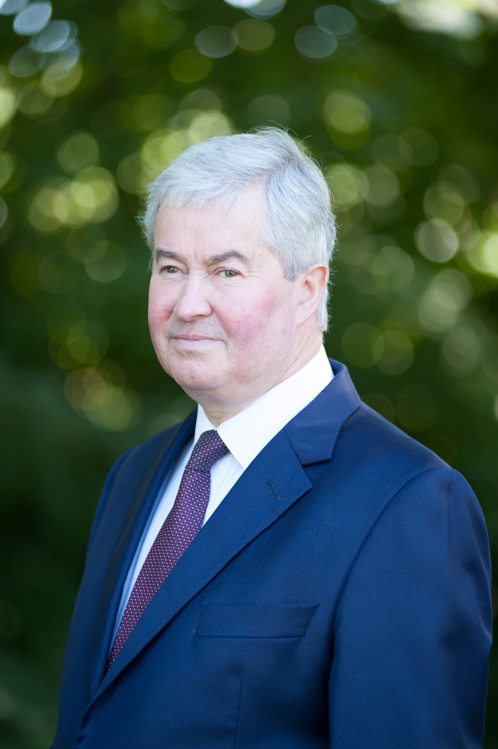 Profile photo of General Sir Richard Barrons wearing a blue suit with a purple tie.