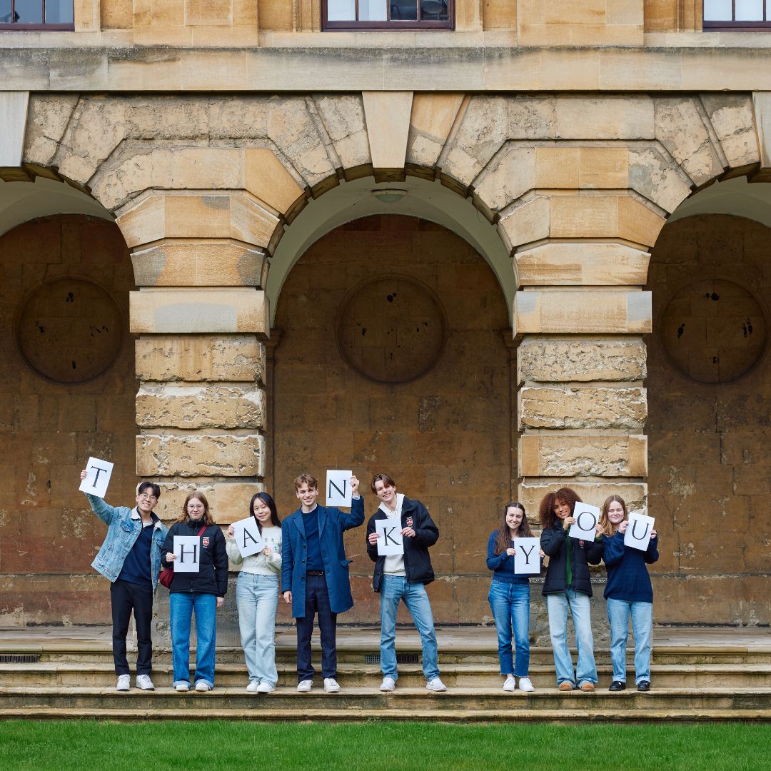 current students holding up the letters that spell 'thank you' in Front Quad