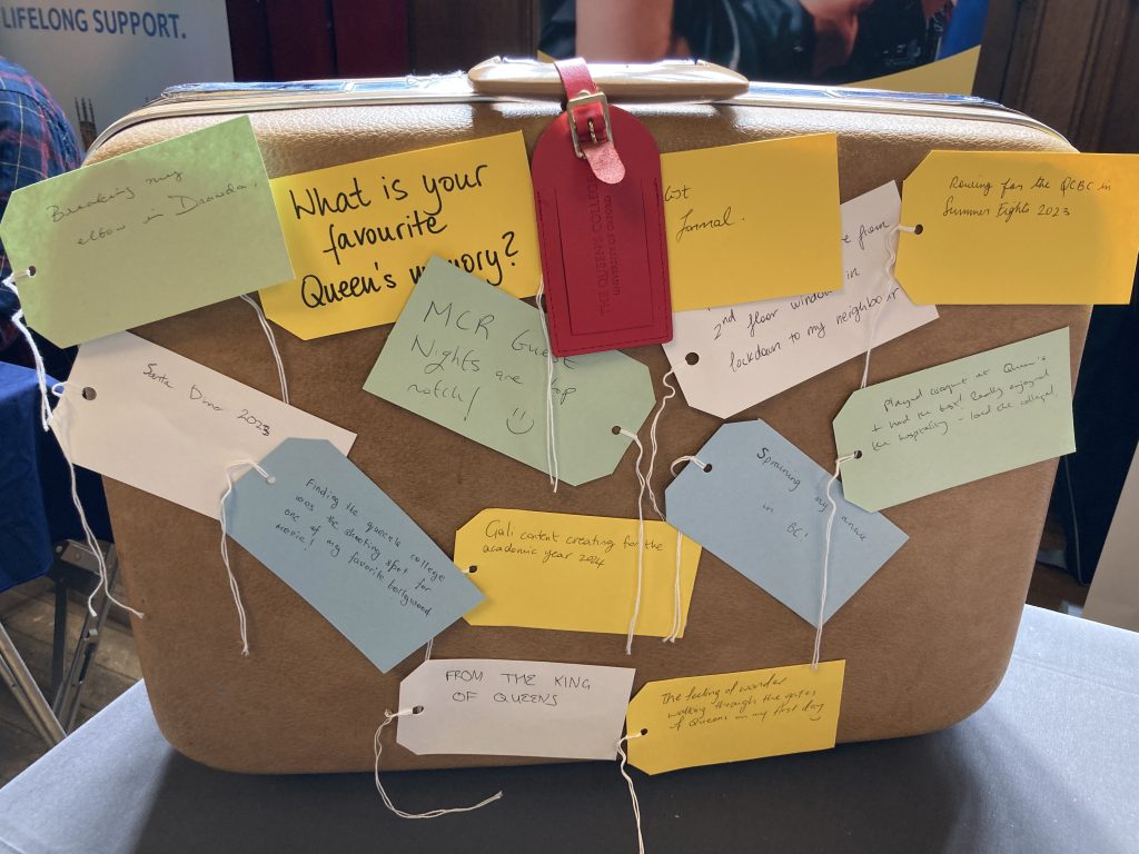 an old style trunk case covered with coloured paper luggage tags containing written memories from recent student leavers