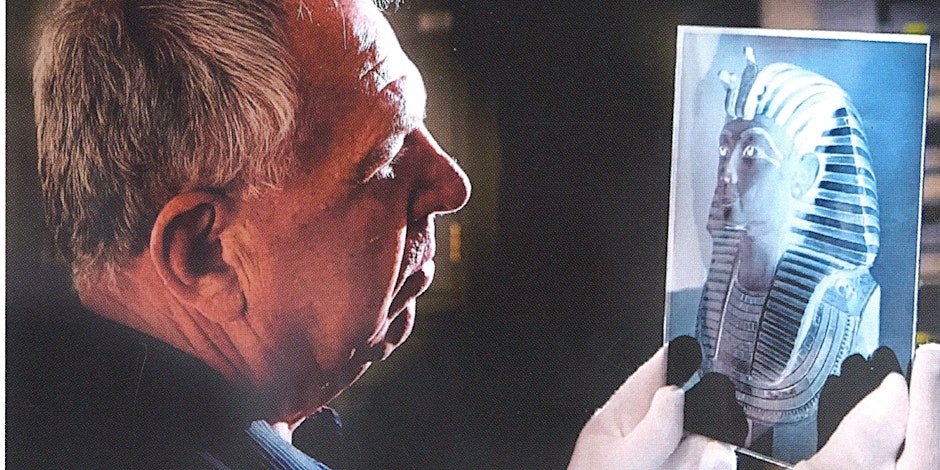 Jaromir Malek looking at an image of an Egyptian artefact