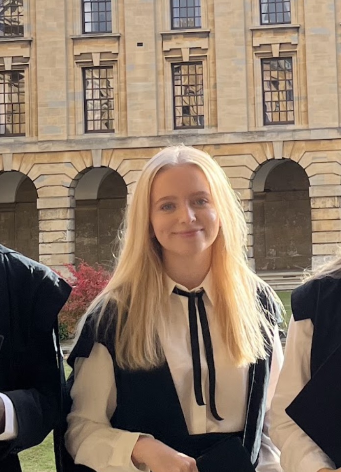 Ellie is pictured wearing subfusc standing in Front Quad